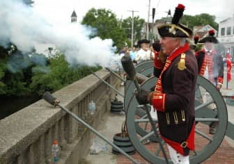 Steve Colonies of the Artillery Company of Newport, mans the cannon as one is fired at the 2014 Gaspee Days Parade. 