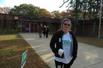 Shelagh McCahey, a volunteer for Senator Erin Lynch, outside Norwood School Tuesday morning.
