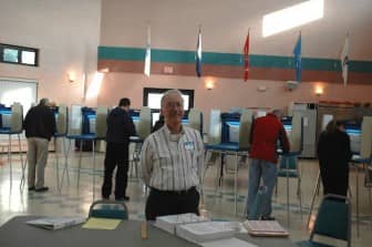 Ken Tata, election clerk at Pilgrim Senior Center, during the 2014 election.