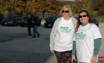 From left, Tracey Knox and Kim Seebeck hold signs for Senator Erin Lynch.