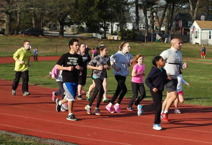 Ron Celio runs with the members of the Warwick Wolves Thursday at Pilgrim High School.