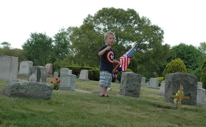 Dylan D'Antonio, 4, at Charles and Ellen Fitzpatrick tend to their own cemetery plots Memorial Day at Pawtuxet Memorial Park with his family, including his aunt, Amy Cariosi, there to pay respect to  passed family, including great-great grandfather William Morgan, who served in WWII.