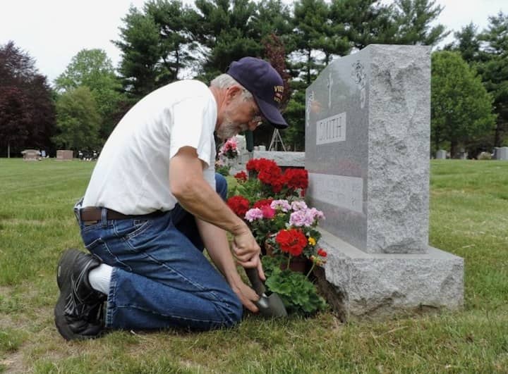 Lincoln Smith cares for the graves of his parents, Rev. Lincoln and Charlotte A. Irwin Smith in Pawtuxet Memorial Park.