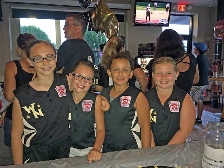 From left, Amelia Murphy, Anjle Williams, Alayna Medna and Sophia Stogner at Dave's Bar and Grill,  where patrons packed the house to watch the Warick Girls North in the Little League Softball World Series Aug. 18.