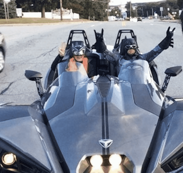 A snapshot of the Polaris Slingshot driven by a Batman and Batgirl costumed duo Saturday night near Oakland Beach.