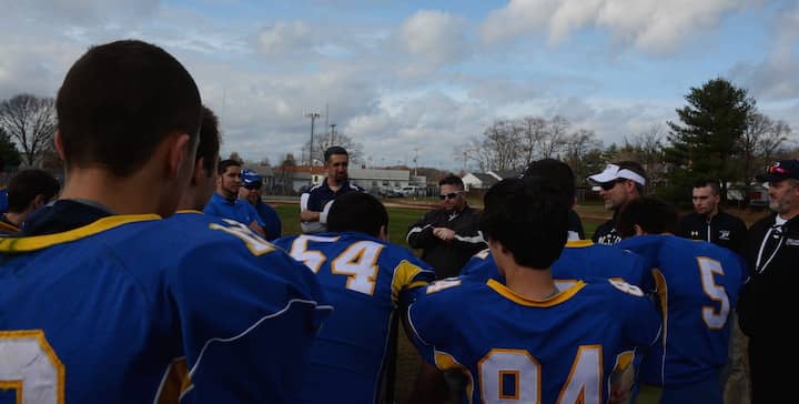 Coach Rob Pacifico, left, and Coach Thomas O'Connor, right, speak with the Hurricanes after their final matchup with the Pilgrim Patriots.