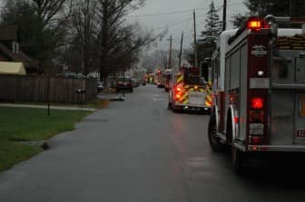 A line of fire engines crowded Eaton Avenue as about 25 firefighters worked to put out a fire at 39 Eaton Ave. Friday morning.