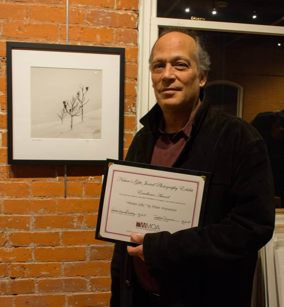 Peter Anjoorian with his Excellence Award winning photo, "Winter Lilly" at WMOA Wednesday night.