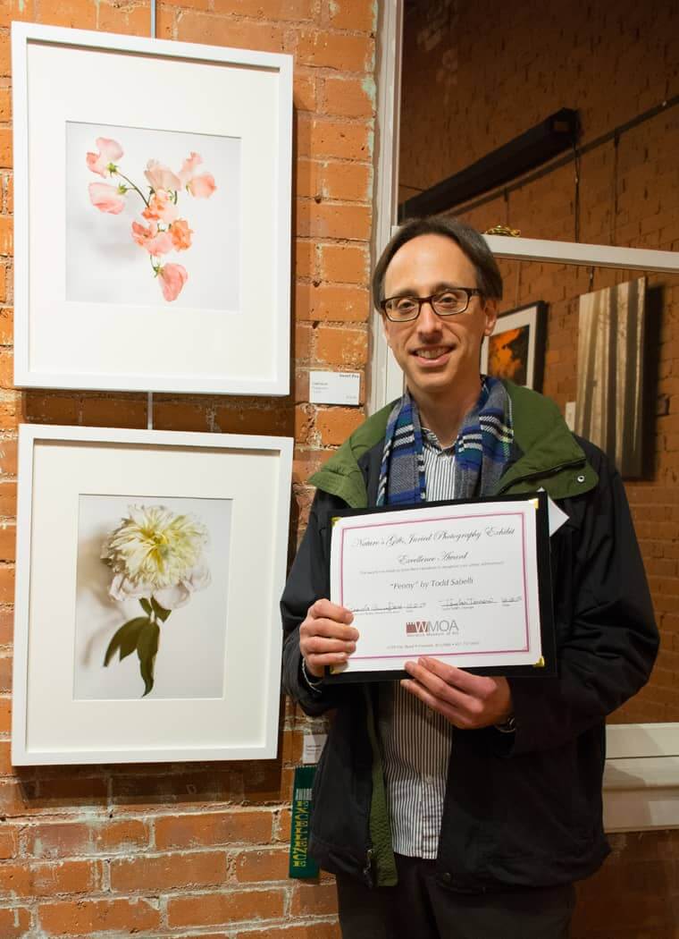 Todd Sabelli with his photo, "Peony", at bottom, winner of one of two excellence awards at WMOA's opening for the "Nature's Gift" exhibit.