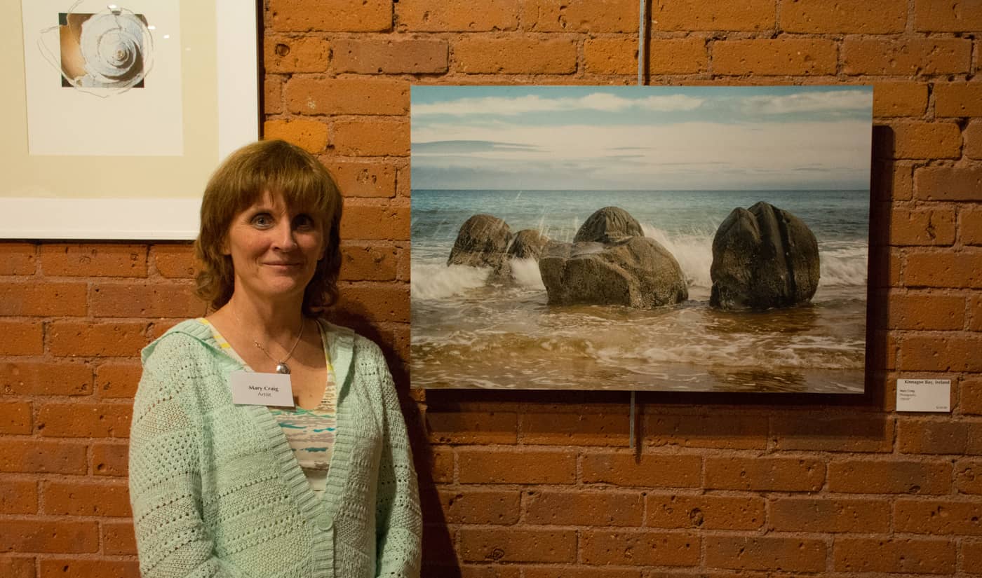 Mary Craig with her photo, Kinnagoe Bay, Ireland at WMOA Wednesday night.