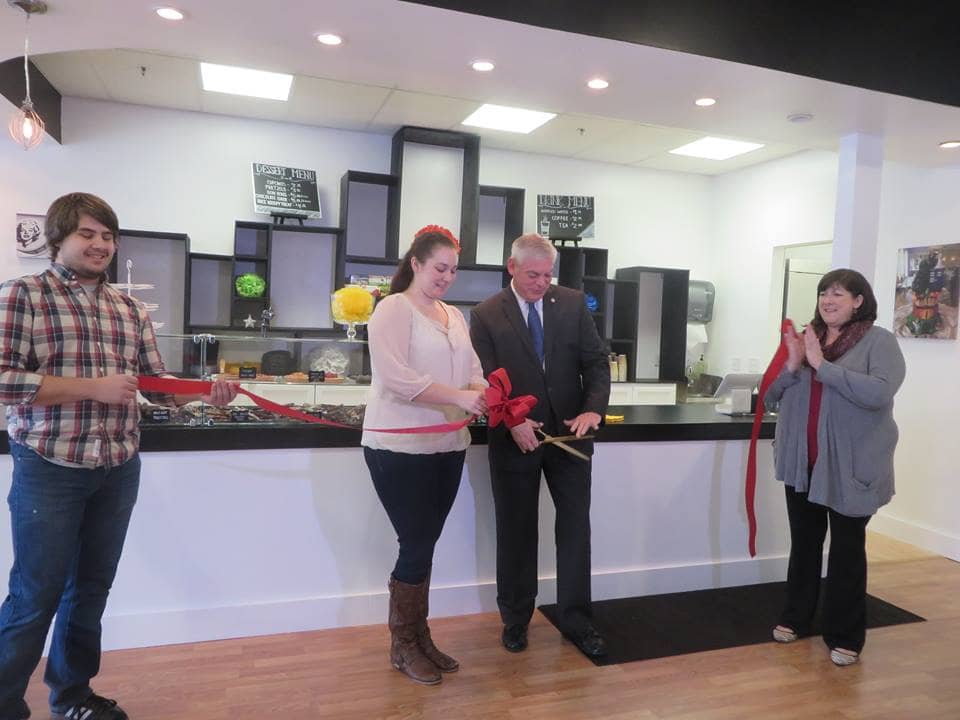 [CREDIT: Mayor Scott Avedisian's Office] Mayor Scott Avedisian and Brittany Rea, owner of A Piece of Cake, cut the ribbon Saturday at the shop's grand opening.