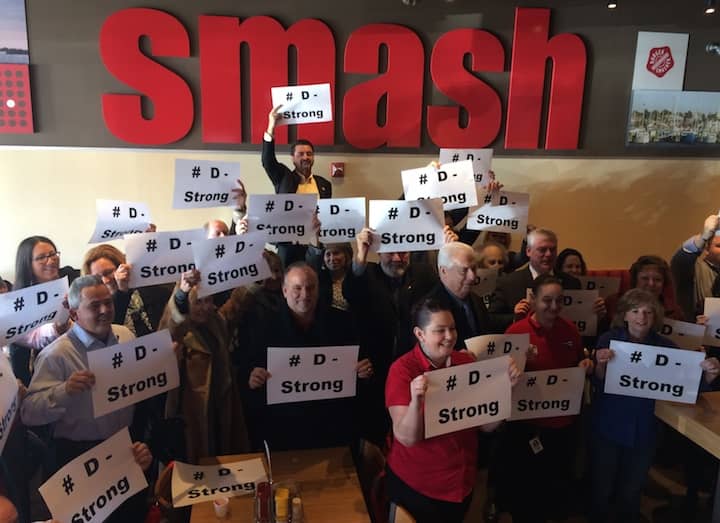 [CREDIT: Rob Borkowski] Smash Burger executives took a moment before the ribbon cutting to show their support for Dorian Murray. 