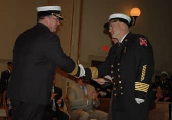 [CREDIT: Rob Borkowski] Asst. WFD Chief David Morse and WFD Chief James McLaughlin shake hands after Morse is sworn in as the new Assistant Fire Chief.