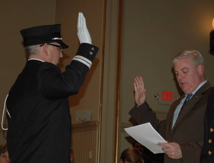 [CREDIT: Rob Borkowski] Marcel Fontineau Jr. is sworn in as Captain by Mayor Scott Avedisian.