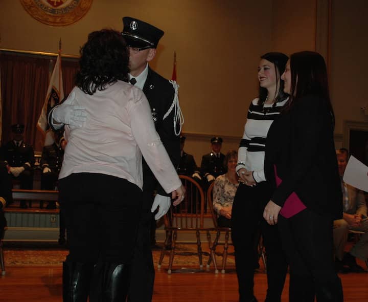 [CREDIT: Rob Borkowski] Marcel Fontineau Jr. gives his wife a kiss after being sworn in as Captain.