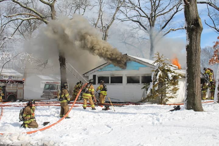 [CREDIT: Chris Palmer] Warwick Firefighters work to extinquish a house fire started in a clothes dryer at 131 Chatworth Ave. Saturday,Feb. 6, at noon. 