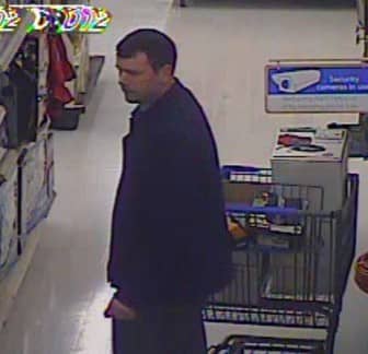 [CREDIT: WPD] Warwick Police are searching for this man, who they say loaded several power tools into a trash can at WalMart and carted it out the door without paying. In this photo, the man is moving his soon to be stolen goods past a video surveillance sign.