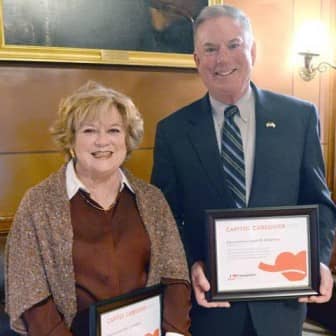 [CREDIT: Legislative Press Bureau] Rep. Eileen Naughton (D-Dist. 21, Warwick), left, and Rep. Joseph McNamara (D-Dist. 19, Warwick) receive an AARP Capitol Caregiver certificate of appreciation from at the State House on Wednesday, March 9. The legislators were honored for their support of legislation supporting family caregivers in Rhode Island.