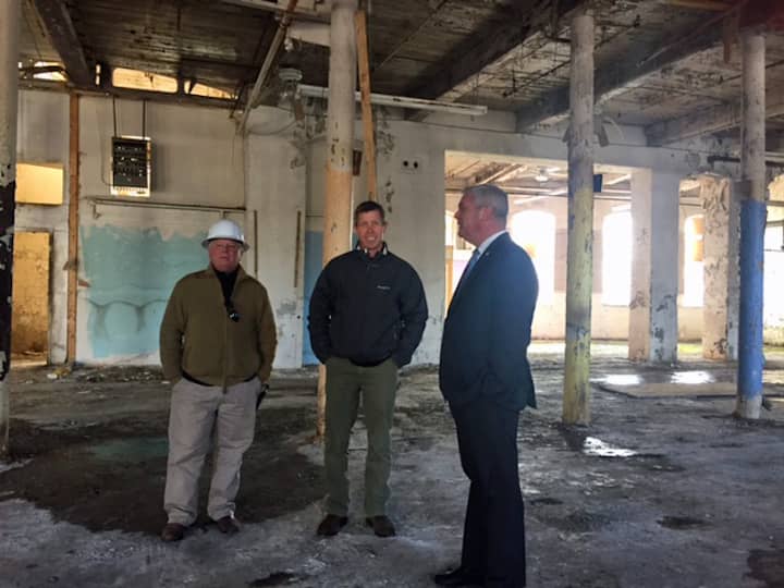 [CREDIT: Courtney Marciano] Mayor Scott Avedisian, developer Larry Silverstein, and Project Manager Michael Harrington toured Pontiac Mill Wednesday, March 2.
