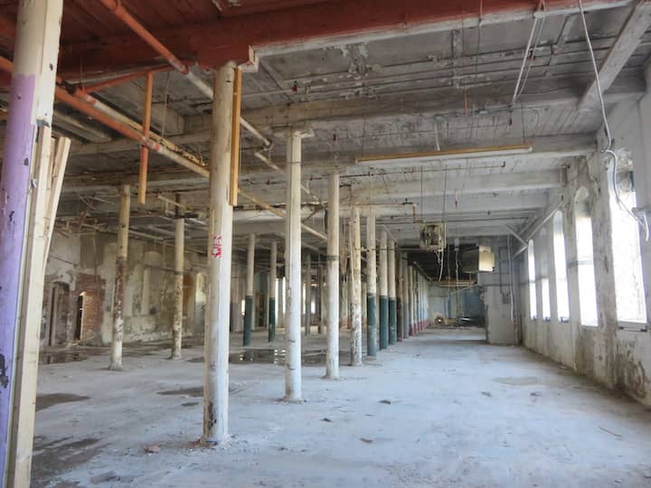 [CREDIT: Courtney Marciano] Mayor Scott Avedisian, developer Larry Silverstein, and Project Manager Michael Harrington toured Pontiac Mill Wednesday, March 2.