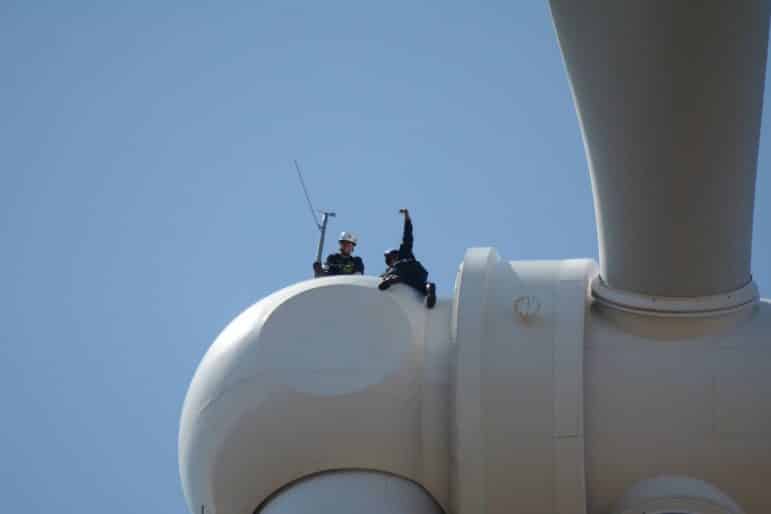 [CREDIT: Rob Borkowski] Rescuer Firefighter Randal Horne, left, and victim Firefighter Tim Bedard train at the top of a NK wind turbine as safety Lt. Rob Cembor monitors from inside the nacelle. 