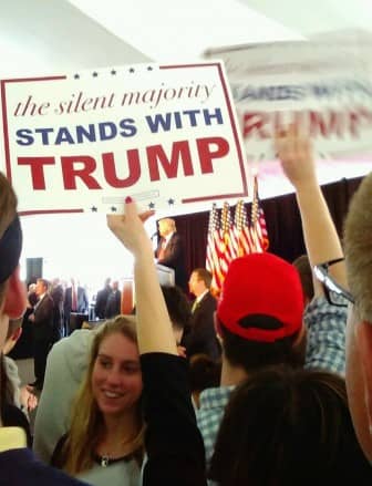 [CREDIT: Tina Suttles] A Trump supporter wielding a sign for the candidate inside the tent at Crowne Plaza April 25.