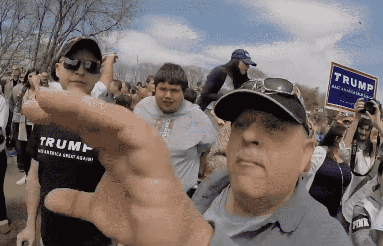[CREDIT: Roderick Webber] A man reaches for Roderick Webber's camera during the rally for Donald Trump at Crowne Plaza April 25.