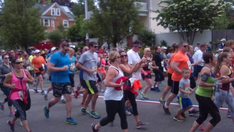 [CREDIT: Tina Suttles] Runners Jog down Narragansett Parkway in the 2016 GaspeeDays5K June 11. 