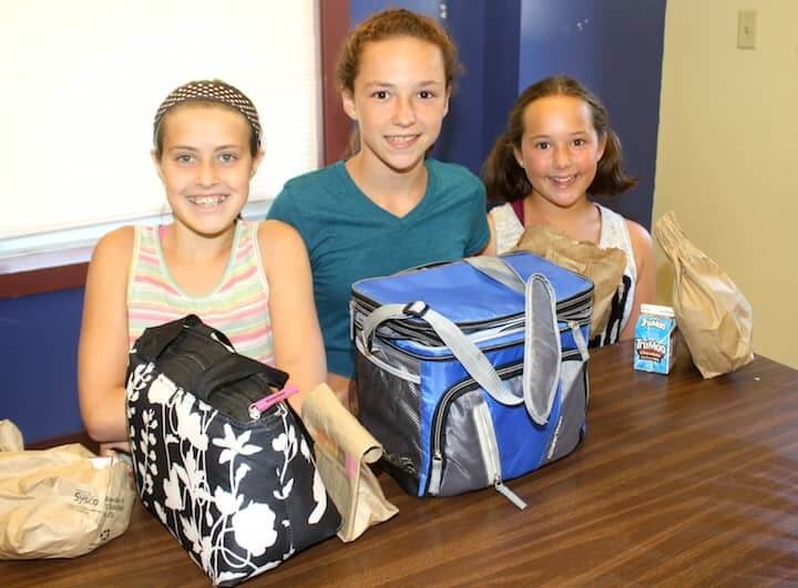 [CREDIT: Beth Hurd] Eagerly awaiting their turns at lunch are Morgan Cole, 11, Myah Cole, 12, and Ally Yabet, 10, who all brought lunches from home. It is Ally's second year at camp, Morgan and Myah's sixth - all love attending the Boys & Girls Club camp. 