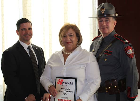 [CREDIT RIAG] Victim Advocate Ana Giron accepts the State Victim Services award from MADD-RI Executive Director Eric Creamer and Rhode Island State Police Colonel Steven G. O’Donnell
