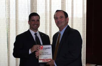 [CREDIT RIAG] Assistant Attorney General Stephen Regine accepts the Statewide Prosecutor of the Year award from MADD-RI Executive Director Eric Creamer
