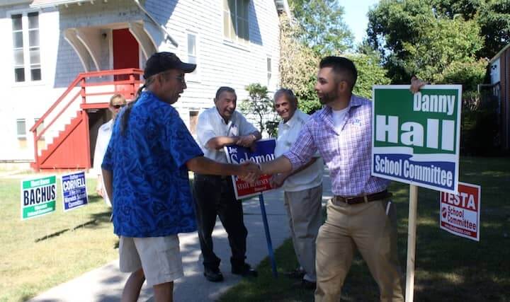 [CREDIT: Beth Hurd]  At left, Danny Hall, democrat running for school committee, greets a voter in front of the polling place at Heritage Christian Fellowship Church on Warwick Neck Avenue.