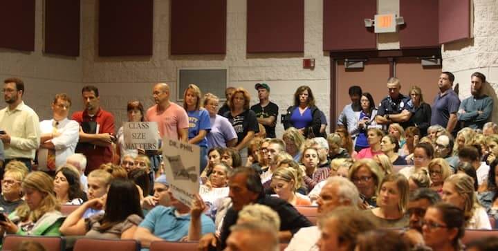 [CREDIT: Beth Hurd] A crowded room of angry parents and teachers protested unfinished conditions at Pilgrim High and Warwick Veterans Middle School Tuesday night during the Warwick School Committee meeting at Toll Gate High.