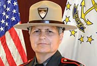 A head shot of State Police Superintendent Ann Assumpico, American flag in the background.