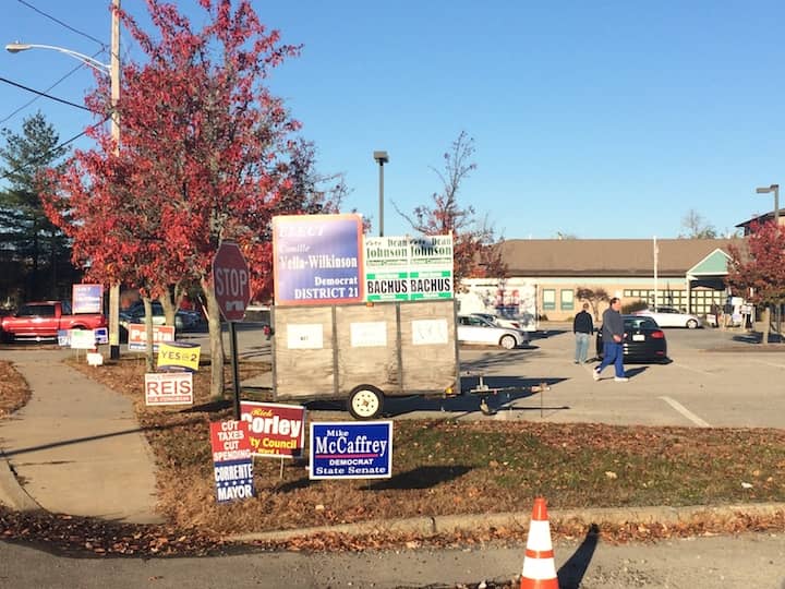 [CREDIT: Rob Borkowski} A large number of signs decorated the sidewalk outside Pilgrim Senior Center during voting day Nov. 8, 2016.