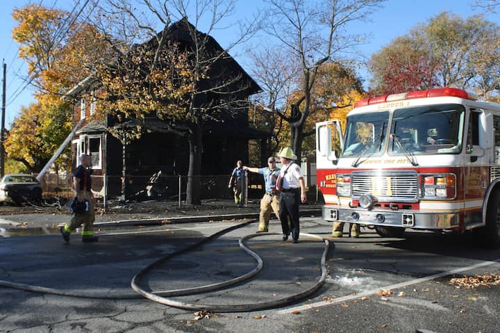 [CREDIT: Beth Hurd] WFD Firefighters monitored the home at 550 Oakland Beach Ave. after fire gutted it Sunday afternoon.