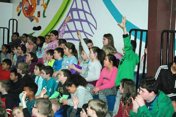 [CREDIT: Rob Borkowski] Cadenc Costa asks a question of Providence Bruins' Danton Heinen Thursday at the Boys & Girls Club Oakland Beach. 