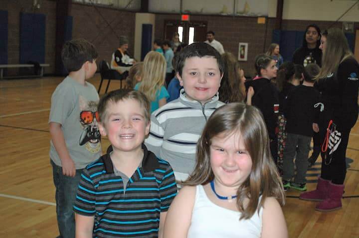 [CREDIT: Rob Borkowski] Elijah Larney, Joseph Martin and Abbey Miller in line for an autograph from Providence Bruins' Danton Heinen.