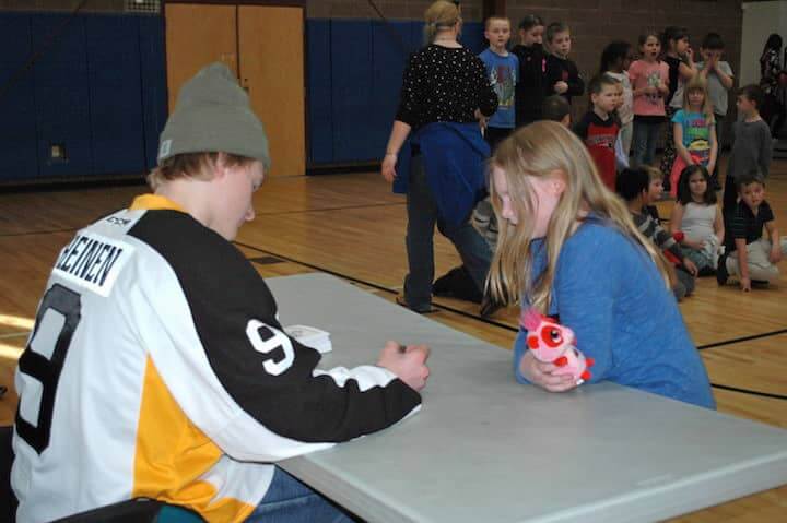 [CREDIT: Rob Borkowski] Providence Bruins' Danton Heinen signs an autograph for Lindsey Canpanile. 