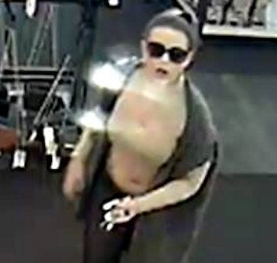 [CREDIT: WPD] A video still of a woman police say stole a credit card then used it to buy shoes at DSW.