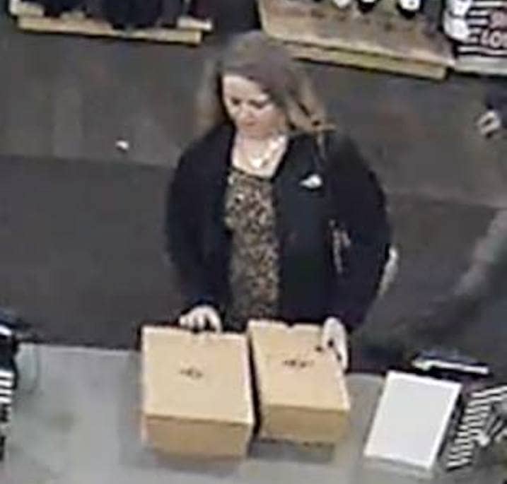 [CREDIT: WPD] A video still of a woman police say stole a credit card then used it to buy shoes at DSW.