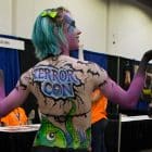 [CREDIT: Mary Carlos} An airbrushed member of the Providence Roller Derby shows off her temporary art during the 2014 Terror Con.