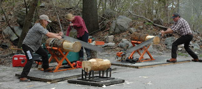 [CREDIT: Rob Borkowski] Dave Weatherhead and Tyler Alden race to saw through a log during Timberworks Lumberjack Show at the grand opening of Duluth Trading Company on Bald Hill Road.
