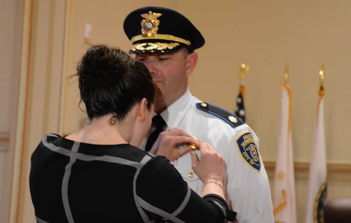 [CREDIT: Rob Borkowski] Maj. Brad Connor's wife pins his new rank on his shirt April 25.