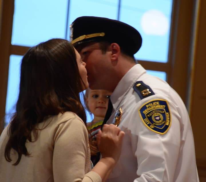 [CREDIT: Rob Borkowski] Ryan T. Sornberger's girlfriend, Jessica Andreas, pins his new rank on as their daughter, Marin, 16 months, watches. The couple are expecting another child, a boy, in September.