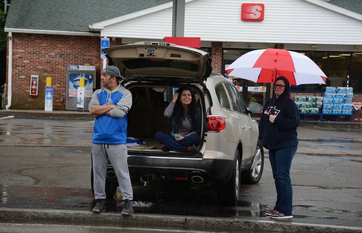 [CREDIT: Rob Borkowski] From left, Harvey Emery, Jessica Emery, and Jessica Wright watch the Wawrick Memorial Day Parade from West Shore Road.