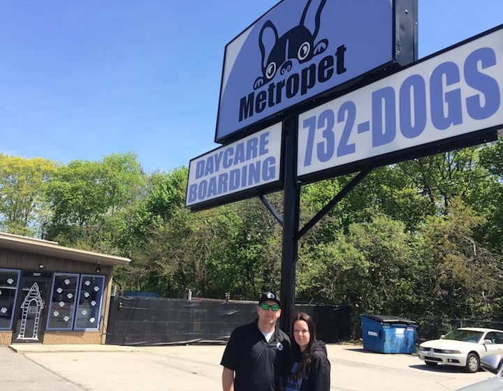 [CREDIT: Rob Borkowski] MetroPet owners Tim and Susan Bedard outside the dog daycare center, which sports a new logo and sign.