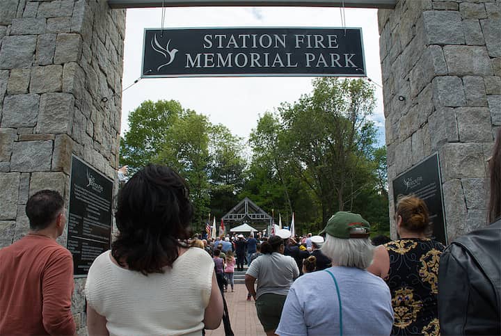 [CREDIT: Mary Carlos] A gathering crowd waits for the Station Memorial dedication Sunday.