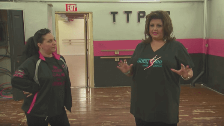 [CREDIT: Lifetime Network] A still shot from the Lifetime Network's episode of Dance Moms featuring the now-defunct Triple Threat studio. From left, studio owner Marlaina F. Rapoza and Dance Moms host Abby Lee Miller.