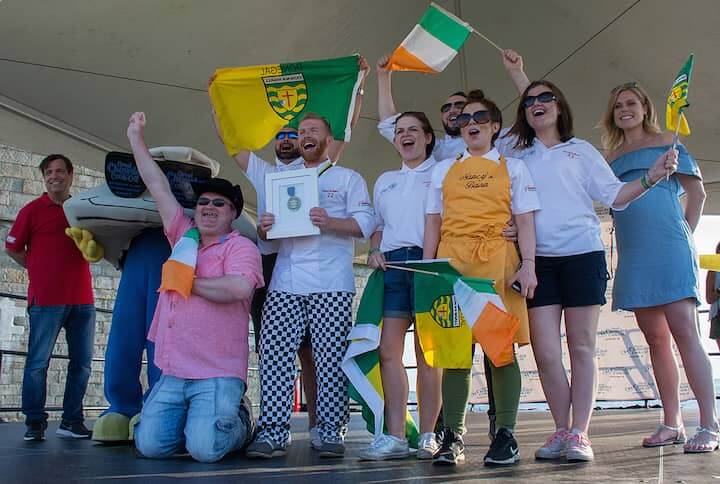 [CREDIT: Mary Carlos] A wildly excited group from Nancy’s Barn, Ballyliffin Ireland celebrate their first place win for best seafood during the Great Chowder Cook-Off at Fort Adams, Newport.